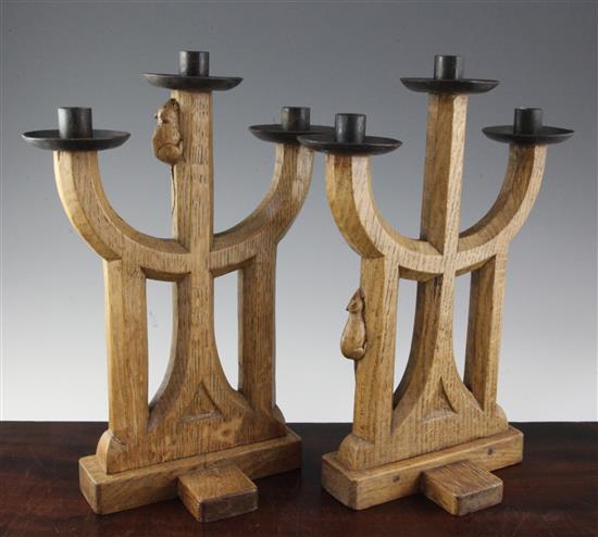 A pair of Robert Mouseman Thompson carved oak three light candelabra, 15in.